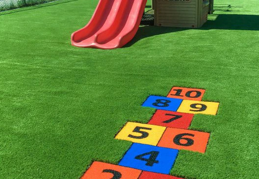 Artificial turf for playgrounds